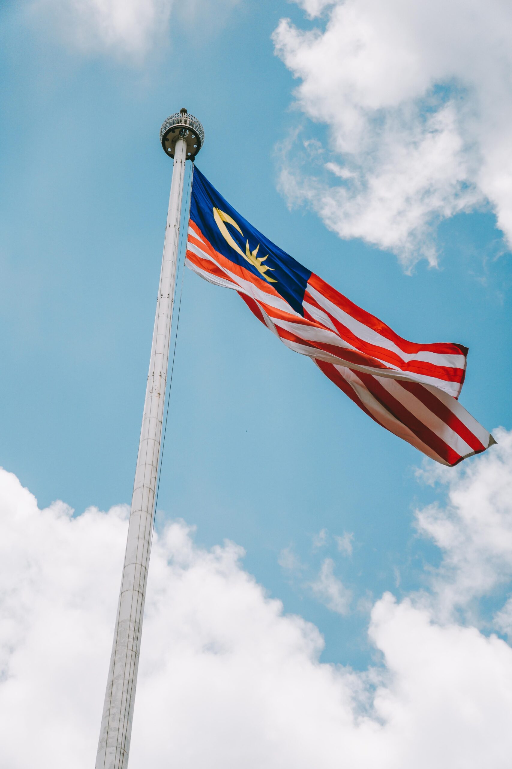 Malaysian flag waving against the sky